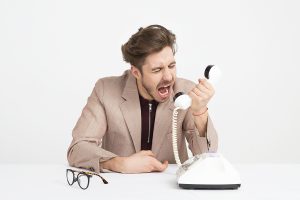 man yelling at a phone