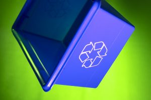 Storage bin with the recycling sign on it.