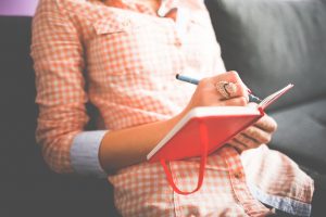 women writing a plan when moving with a baby