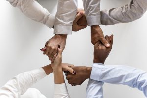 A group of people holding hands.