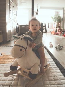 baby riding rocking horse