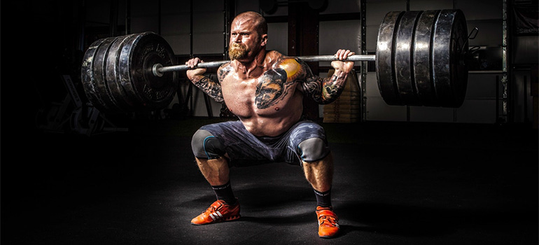 A strongman lifting weights and showing how strong you must be to disassemble and pack a bunk bed