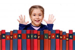 girl showing her books you will pack first before Packing the nursery