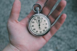 a hand holding a pocket clock