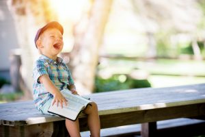 Help your kids cope with moving by having them read a book on the bench