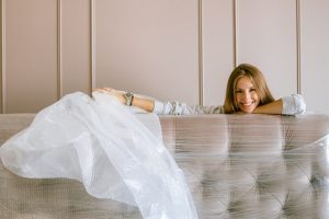 Woman preparing her belongings for storing after reading a guide on how to organize your storage unit