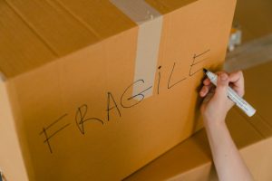 A person labeling moving boxes