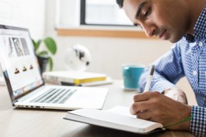 Man researching on a laptop the Ultimate guide to moving to Kendall, FL