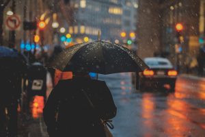 person holding a black umbrella