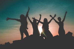 girls jumping in the sunset