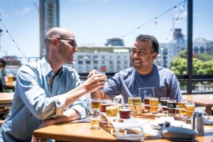 two men drinking beer in a restaurant