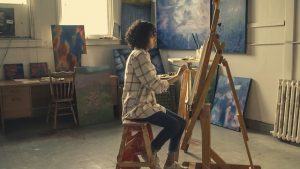 Woman painting in her studio