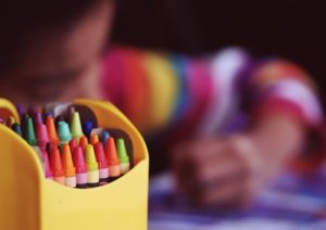 zoomed crayons and a blury child in the background