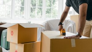 man packing cardboard boxes