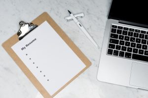 empty resume, pencil and a laptop