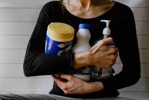 A woman holding bottles for cleaning