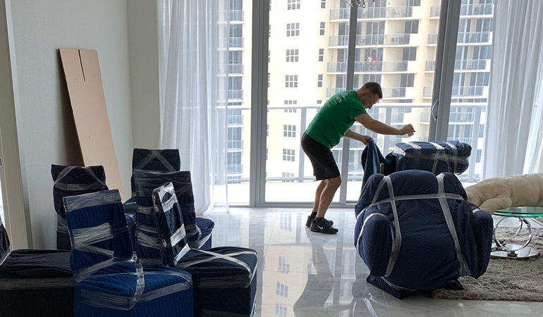 movers in hollywood fl preparing office items for transport.