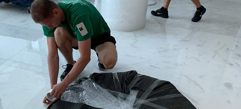 A mover preparing an item for relocation as a symbol of movers Parkland FL