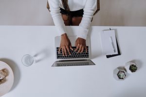 woman typing on a laptop