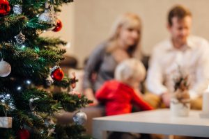 A christmas tree and a family in the background