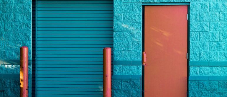 A brown panel door near a storage