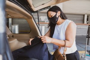 Woman pack boxes in a car