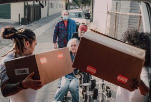 people handing out donation boxes 