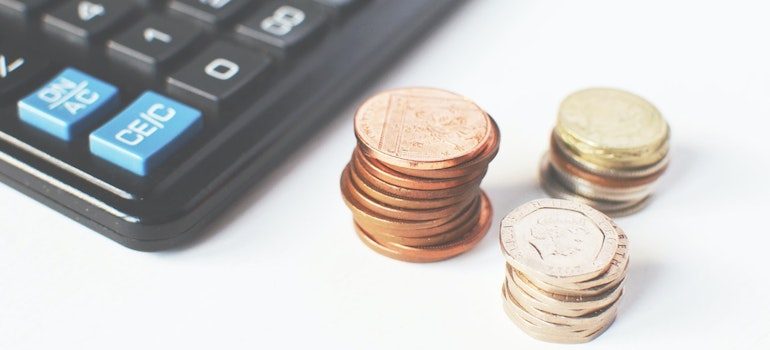 3 towers of coins next to the calculator 