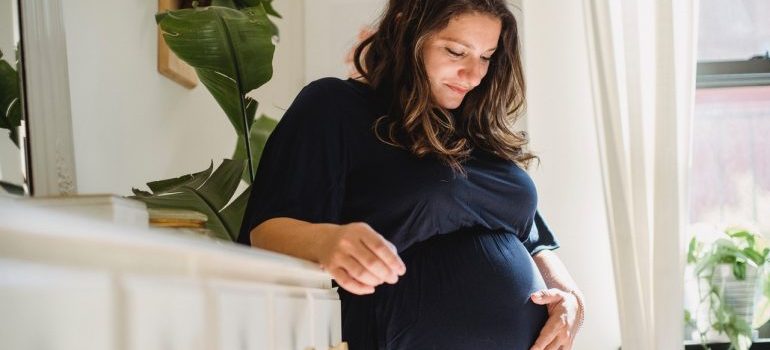 Pregnant woman holding stomach