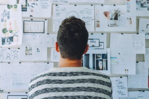 a man looking at a plan on the wall