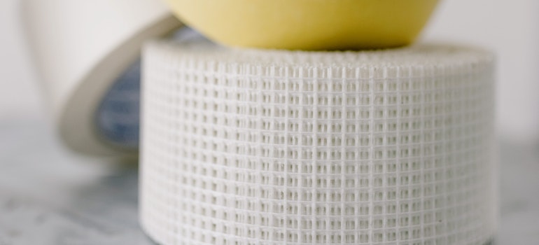 masking tapes on table against a white wall