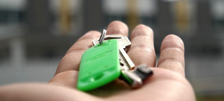 a person holding the house keys on their palm