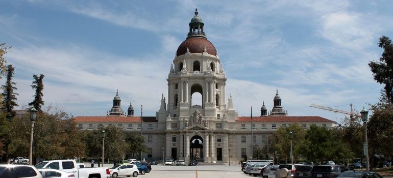 large white building in Pasadena, cars parked on both sides