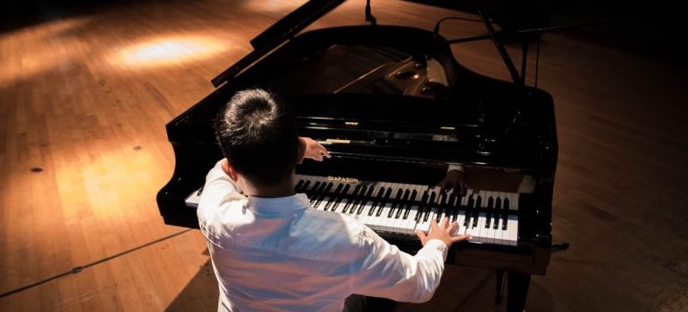 Man playing piano after moving from Florida to Seattle.