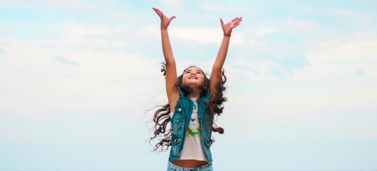 a girl lifting her hands