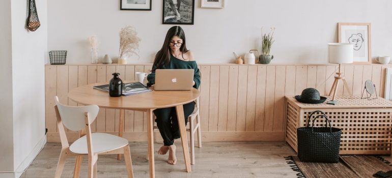 Woman working on the lap top by the table