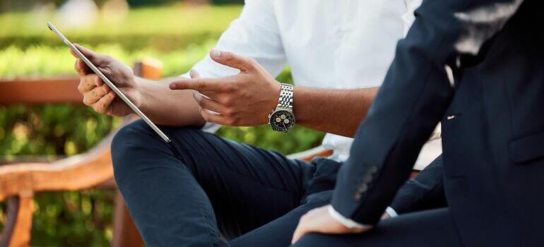 two men looking at the tablet