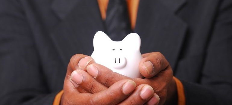 Man in a suit holding a piggy bank