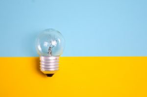 A light bulb on a gold and blue background