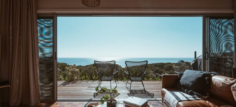 Terrace of the modern villa overlooking the ocean, viewed from the living room. 