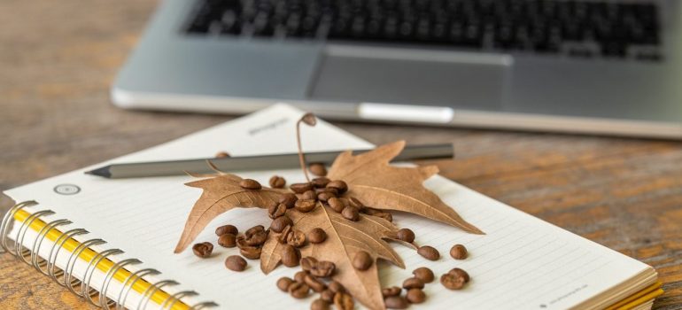 Autumn leaf, laptop and notebook