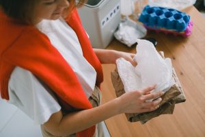 A woman cleans home from clutter. 