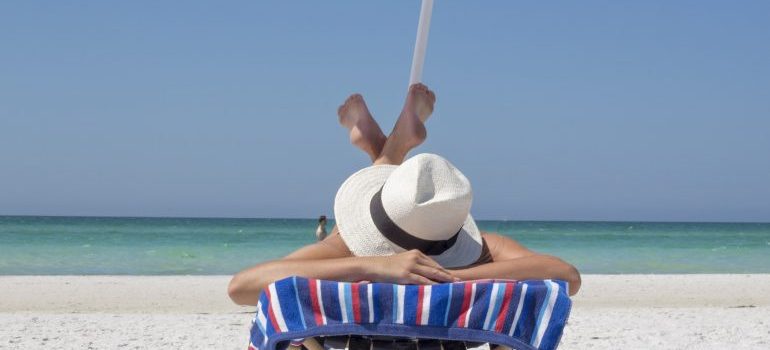 A woman tanning on a beach in Hallandale Beach or North Miami