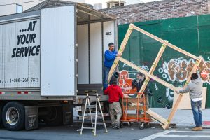 Movers handling a frame