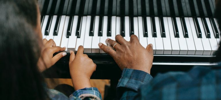 Parent and child playing piano