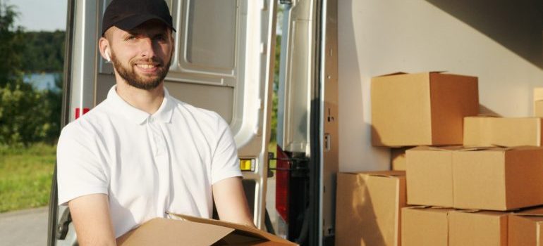 professional movers holding a moving box