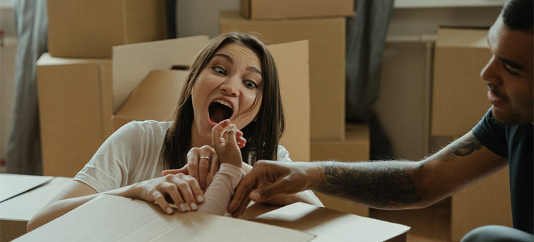 a family playing among boxes