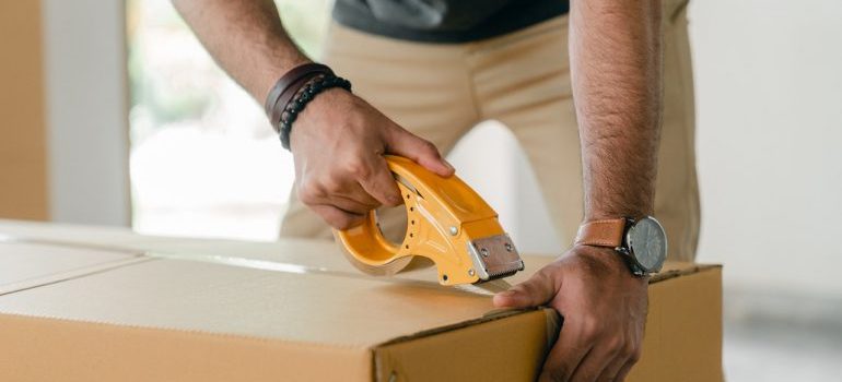 man packing a box