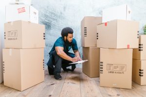 a man from a moving company cataloging moving boxes