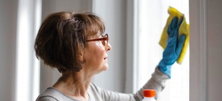 woman cleaning a window